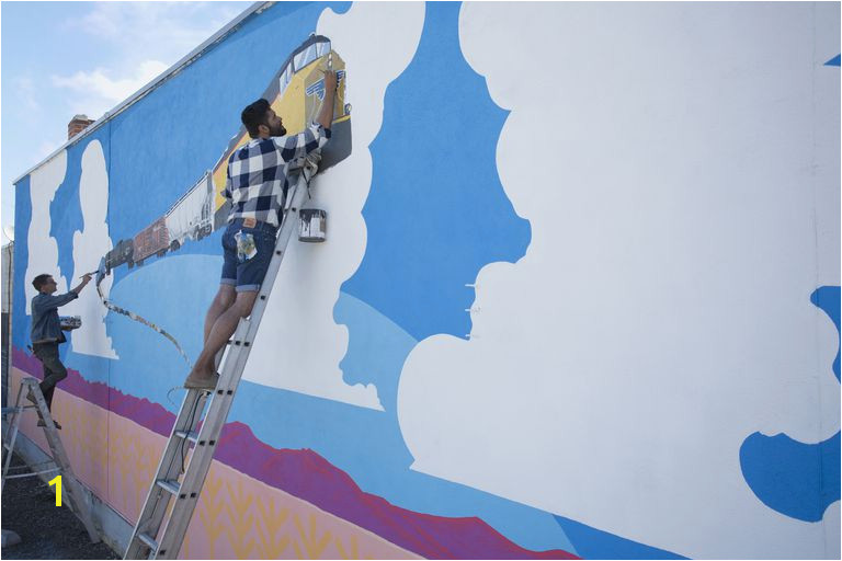 Artists painting mural wall