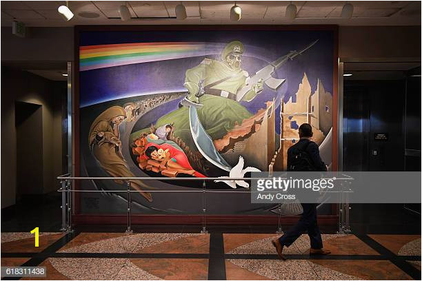 A traveler looks over a wall mural part of an installation at the Denver International Airport