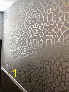 A DIY metallic stenciled bedroom accent wall using the Tea House Trellis Wall Stencil from Cutting