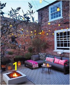 Courtyard garden with outdoor cinema fire pit festoon lights