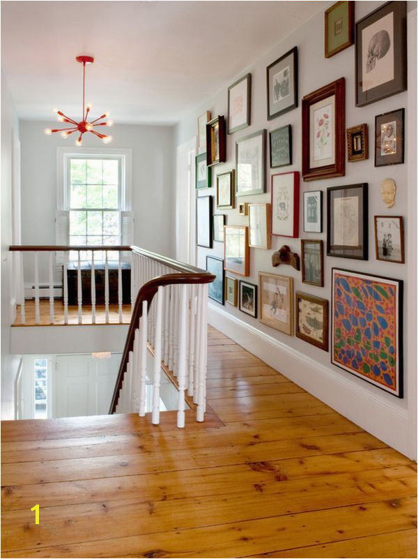 Use an eclectic mix when filling a hallway wall This collection is easier to "see" than a wall of uniform shapes and matching frames