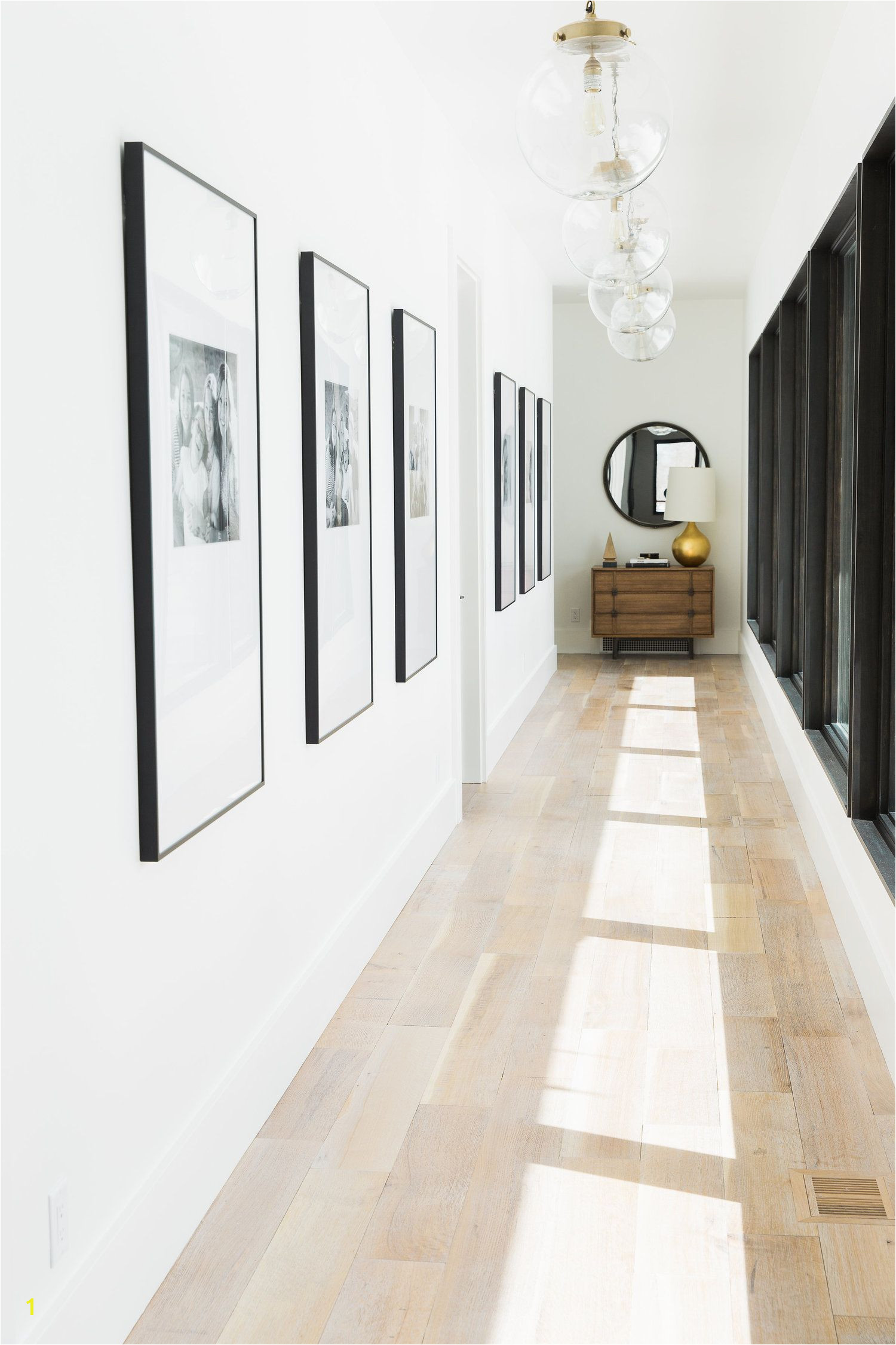 Wall of windows and family pictures Studio McGee