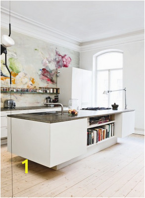 Interesting kitchen island with a modern feel and a wall mural