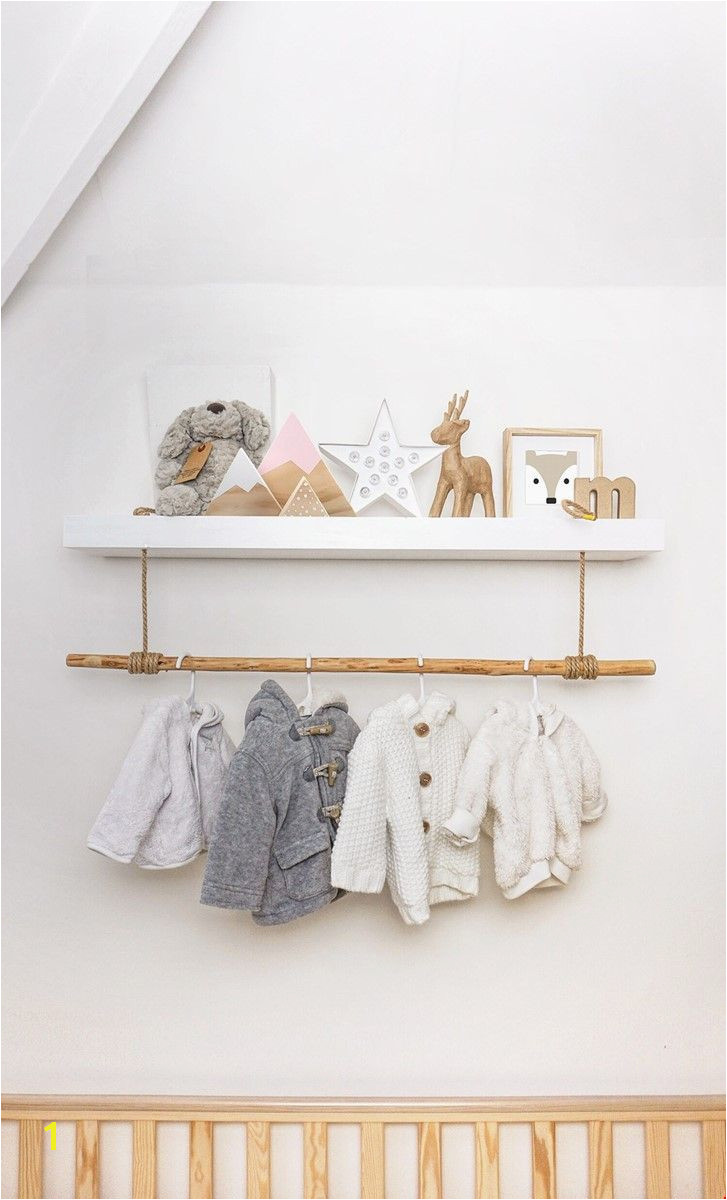 Hack of a standard white floating shelf to add a clothes rail for the new nursery