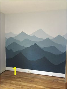 Painted a mountain mural in our nursery Used sherwin Williams Rock Candy and Sea Serpent With golden rays