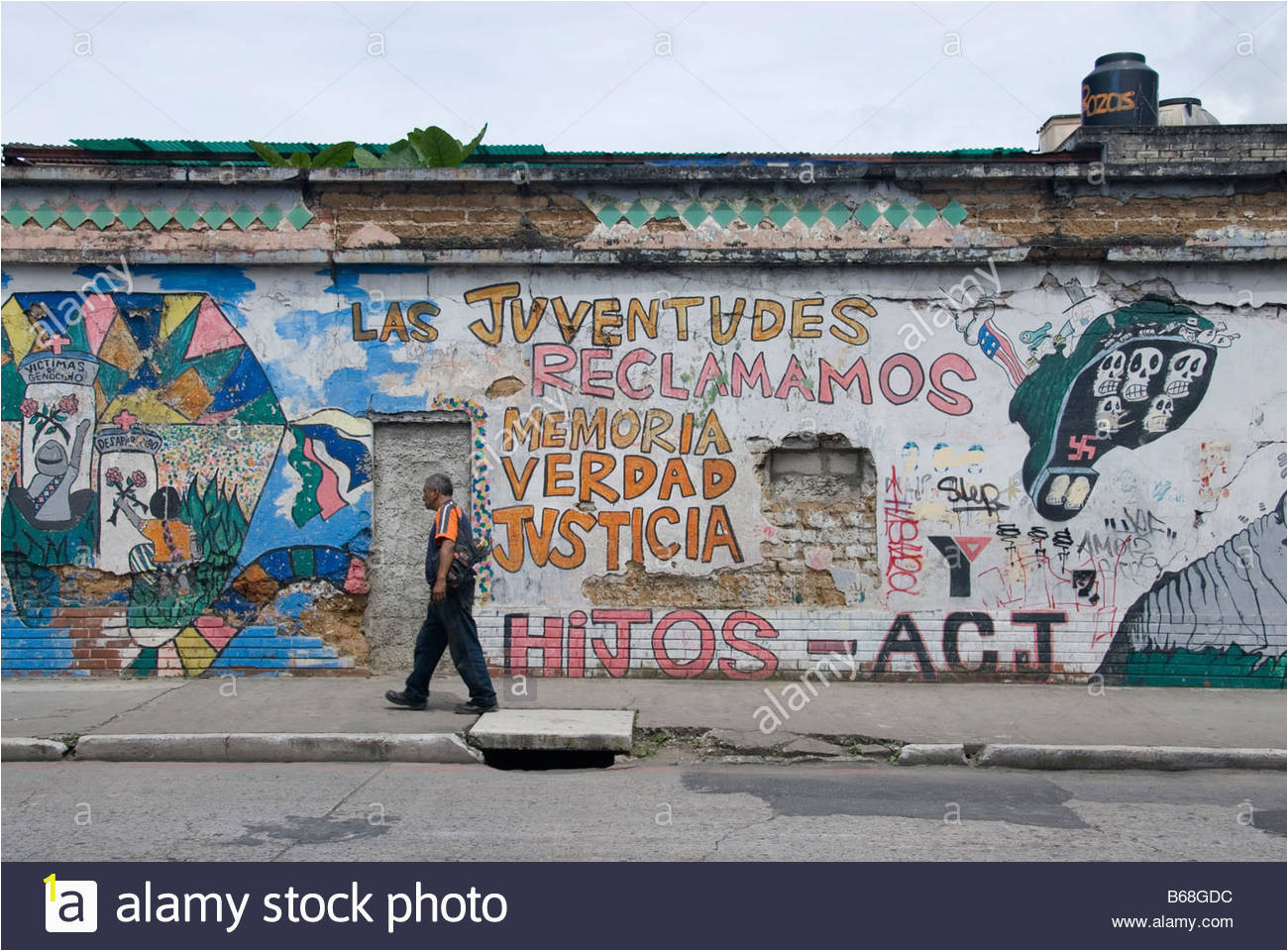 wall in guatemala city covered with political graffity B68GDC