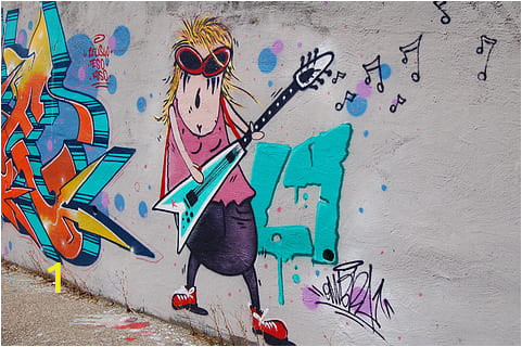 a wall painting of a fat woman wearing rockstar glasses playing an electric guitar thumbnail