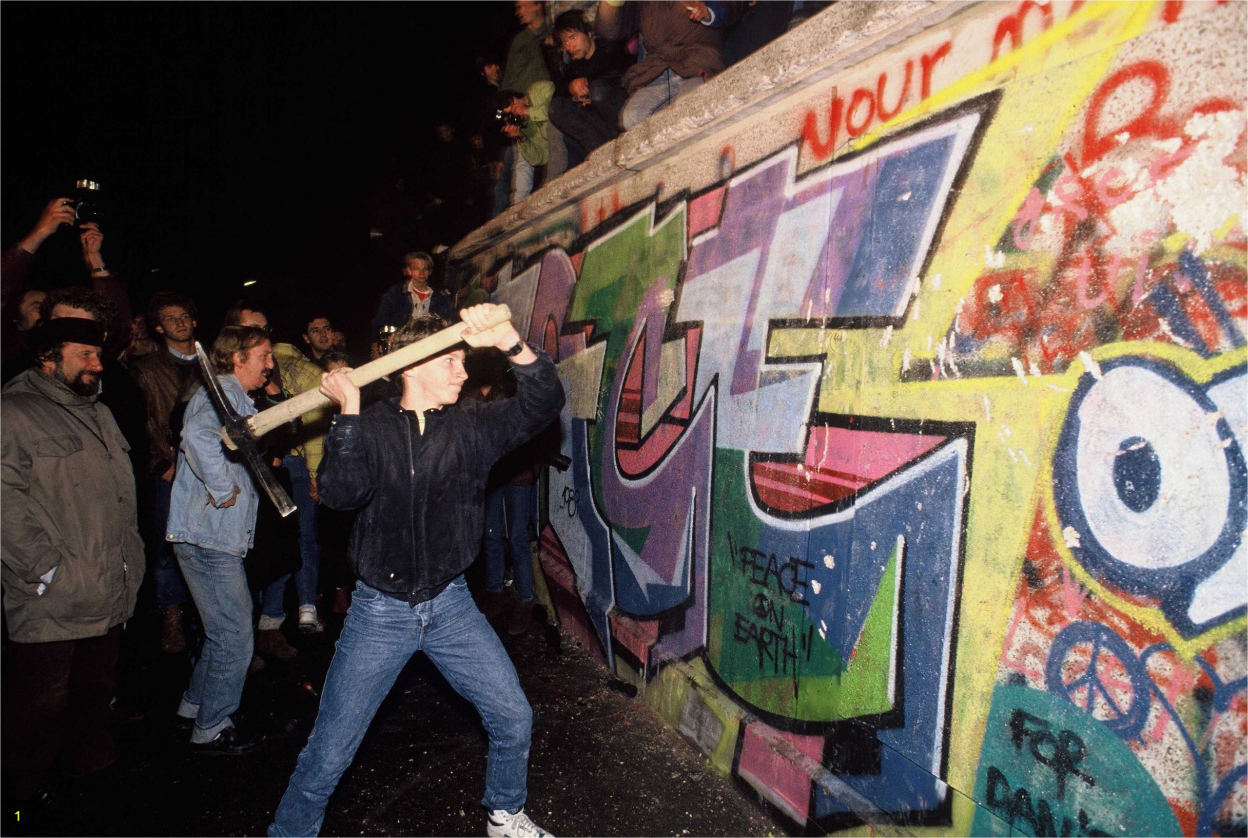 a man s the berlin wall with a pickaxe on the night of november 9th 1989 5c4bd496c9e77c0001d7b994